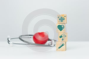 Concept of medical and healthcare. stack wooden cube blocks stacking with medical icons. treatment and medicine symbol signs