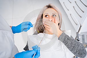 The concept of medicine and dental health, modern dentistry, caries treatment in the clinic, a woman sitting in a dental