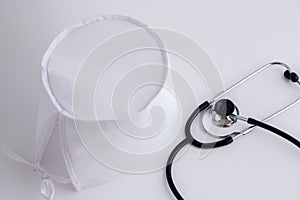 Concept for medicine. Medical items medical cap, tonometer, stethoscope on a white isolated background.