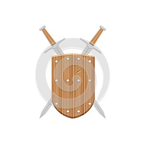 The concept of medieval weapons. A beautiful wooden medieval shield with two crossed swords positioned behind the shield