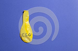 Concept and metaphor of deflated ego. yellow and blue. copy space