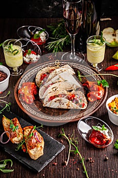 The concept of Mexican cuisine. Mexican food and snacks on a wooden table. Taco, sorbet, tartar, glass and bottle of red wine.