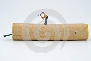 Concept miniature people destroying a Firecracker