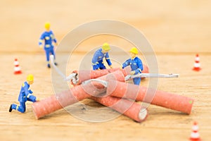 Concept miniature people working on Firecracker