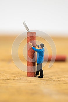 Concept miniature people working on Firecracker