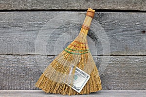 Concept of mismanagement. Broom stuck with dollars photo