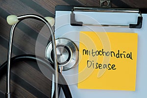 Concept of Mitochondrial Disease write on paperwork isolated on Wooden Table photo