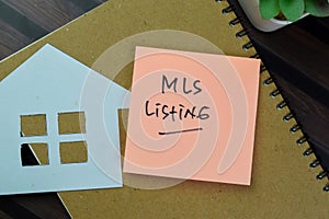 Concept of MLS Listing write on sticky notes isolated on Wooden Table