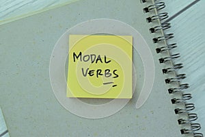 Concept of Modal Verbs write on sticky notes isolated on Wooden Table