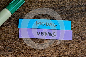 Concept of Modal Verbs write on sticky notes  on Wooden Table