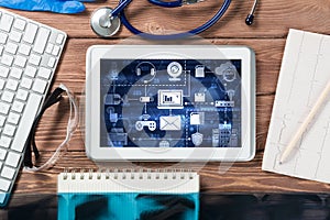 Concept of modern medicine with tablet on wooden table from top view