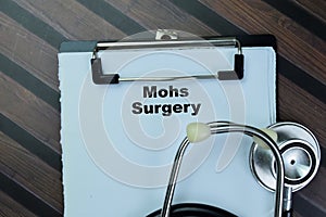 Concept of Mohs Surgery write on paperwork with stethoscope isolated on Wooden Table