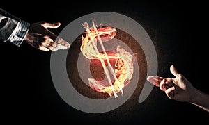 Concept of money making with dollar currency fire symbol on dark