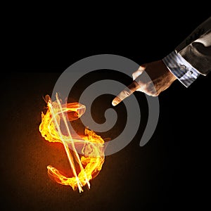 Concept of money making with dollar currency fire symbol on dark background