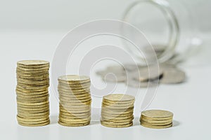 Stacked coins with jar.