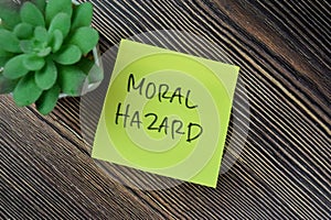 Concept of Moral Hazard write on sticky notes isolated on Wooden Table