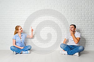 Concept of mortgage housing problems. couple at blank wall