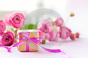 Concept Mother`s Day, Valentine`s Day. Gift present box with beautiful pink flowers roses bouquet