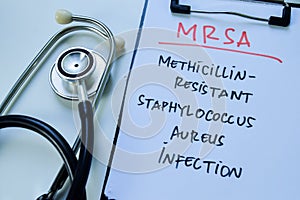 Concept of MRSA - Methicillin Resistant Staphylococcus Aureus Infection write on paperwork with stethoscope isolated on white