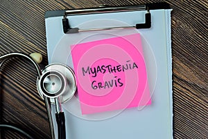 Concept of Myasthenia Gravis write on sticky notes with stethoscope isolated on Wooden Table