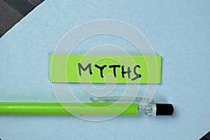 Concept of Myths write on sticky notes isolated on Wooden Table