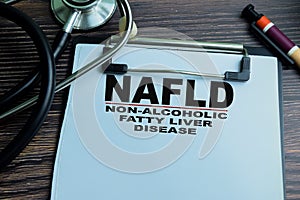 Concept of NAFLD - Non-Alcoholic Fatty Liver Disease write on paperwork isolated on wooden background photo