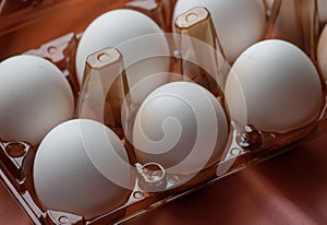 Concept of natural eggs. A tray of eggs on a pink background. eco tray with testicles. minimalistic trend, top view