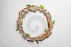 Concept of nature conservation.Dried twigs with leaves in the shape of a wreath on a gray background. Flat lay