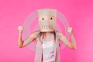 Concept of negative emotions - Angry woman with a paper bag on his face.