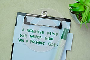 Concept of A Negative Mind Will Never Give You A Positive Life write on sticky notes isolated on Wooden Table