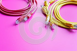 Concept network internet cable on pink background close up