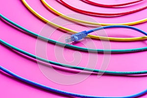 Concept network internet cable on pink background close up