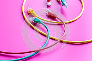 Concept network internet cable on pink background close up