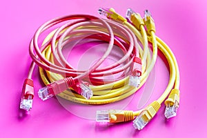 Concept network internet cable on pink background close up