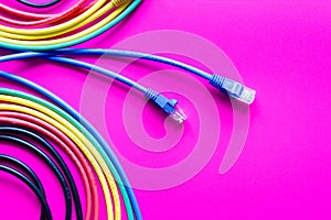 Concept network internet cable on pink background close up