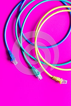 Concept network internet cable on pink background close up