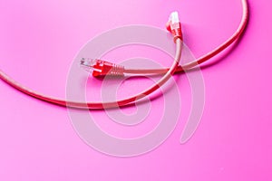 Concept network internet cable on pink background close up