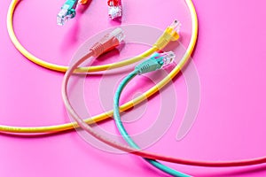 Concept network internet cable on pink background close up