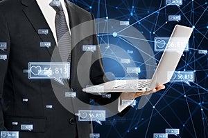 Concept of network and internet communication. Close up of businessman hands holding laptop with creative polygonal likes network