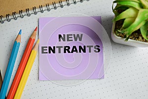 Concept of new entrants write on sticky notes isolated on Wooden Table