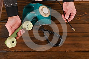 concept of no connection. a wired phone and a broken wire.