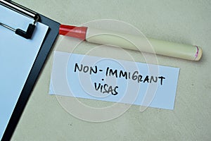 Concept of Non-Immigrant Visas write on sticky notes isolated on Wooden Table