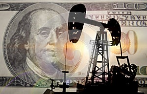 Concept oil and dollar. Installation for drilling a pump oil against a background of one hundred dollars a banknote, money