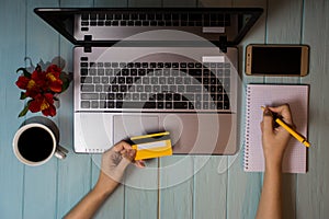 Concept of online new technologies, shopping buy goods. woman buying with debit credit card and laptop in cafe