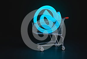 Concept of online shopping. Big blue @ sign lying in shopping ca
