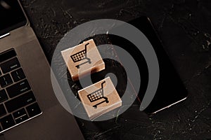 Concept of online Shopping. Boxes, laptop and smartphone on a grey background