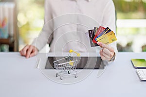 Concept of Online shopping, e-commerce, Woman holding credit card and using laptop computer for shopping online,Businesswoman