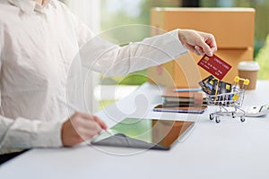 Concept of Online shopping, e-commerce, Woman holding credit card and using laptop computer for shopping online,Businesswoman