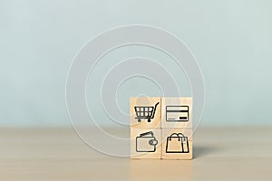 Concept of online shopping. wooden cube blocks with shopping or e-commerce icons on table. business online marketing