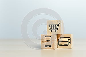 Concept of online shopping. wooden cube blocks with shopping or e-commerce icons on table. business online marketing